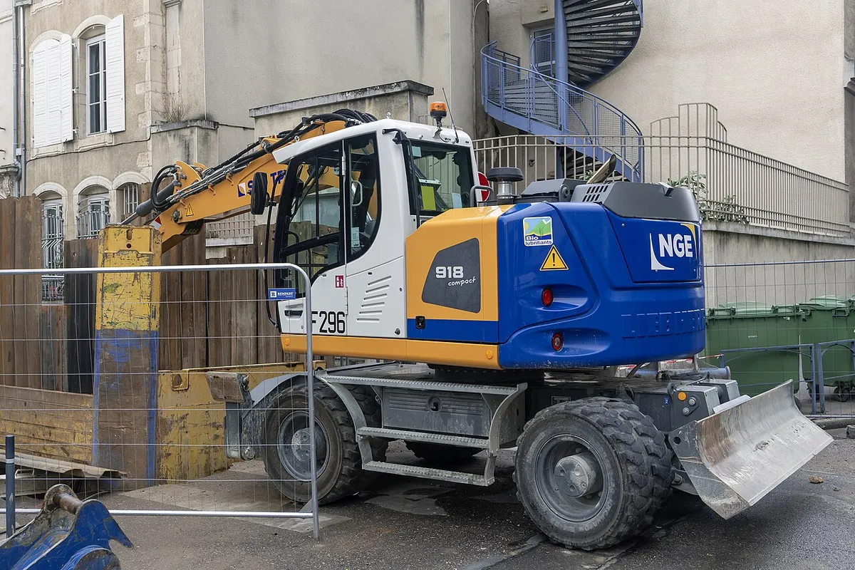 Колёсный экскаватор Liebherr A 918 Compact с задним отвалом на ремонте улицы